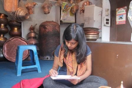 Pooja sketching in a Kashmiri copper shop